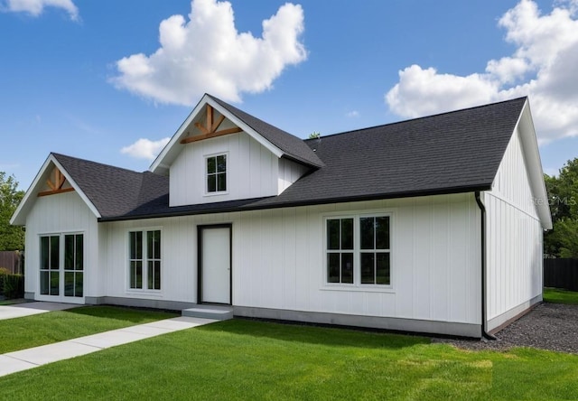 9659 Midway Rd, Haines City, FL 33844 - rear view of property featuring a lawn and roof with shingles