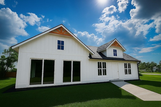 9659 Midway Rd, Haines City, FL 33844 - back of property featuring a lawn and roof with shingles