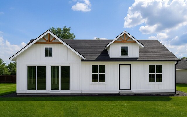 9659 Midway Rd, Haines City, FL 33844 - back of house featuring a lawn and board and batten siding