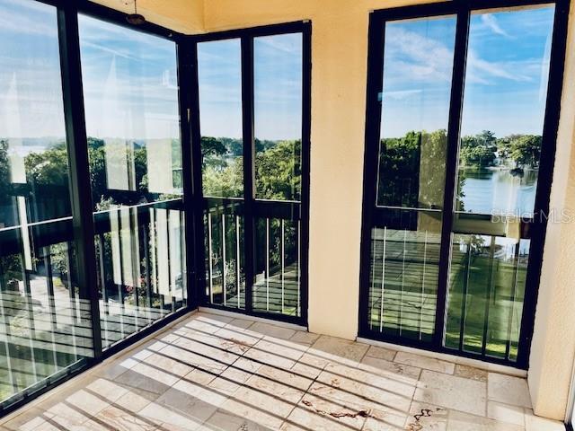 204 Quayside Cir Unit 601, Maitland, FL 32751 - unfurnished sunroom featuring a water view and plenty of natural light