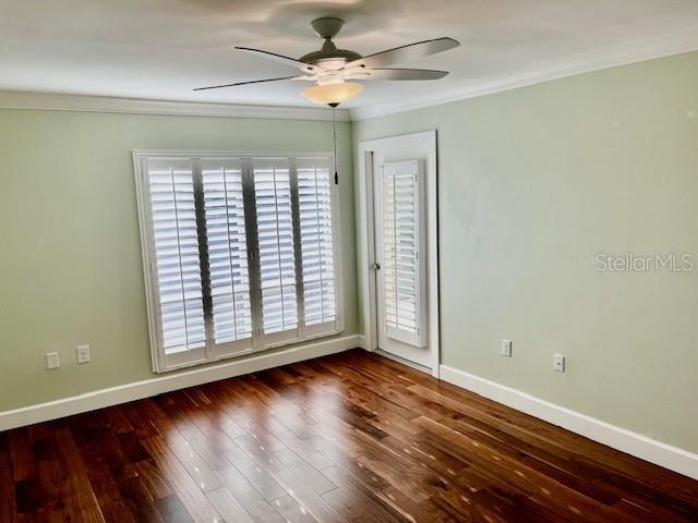 204 Quayside Cir Unit 601, Maitland, FL 32751 - empty room featuring ornamental molding, ceiling fan, and dark wood-style flooring