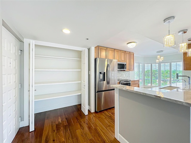 204 Quayside Cir Unit 601, Maitland, FL 32751 - kitchen featuring stainless steel appliances, a chandelier, light stone counters, dark wood-type flooring, and crown molding