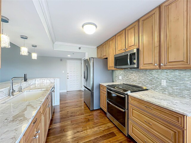 204 Quayside Cir Unit 601, Maitland, FL 32751 - kitchen with stainless steel appliances, crown molding, dark wood-style flooring, tasteful backsplash, and light stone counters