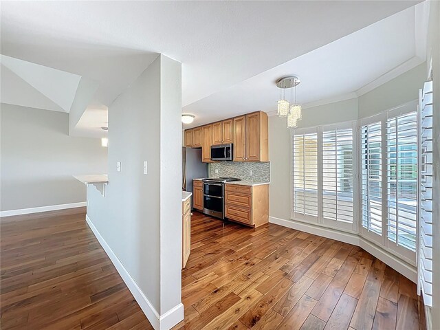 204 Quayside Cir Unit 601, Maitland, FL 32751 - kitchen featuring appliances with stainless steel finishes, dark wood finished floors, light countertops, a chandelier, and ornamental molding