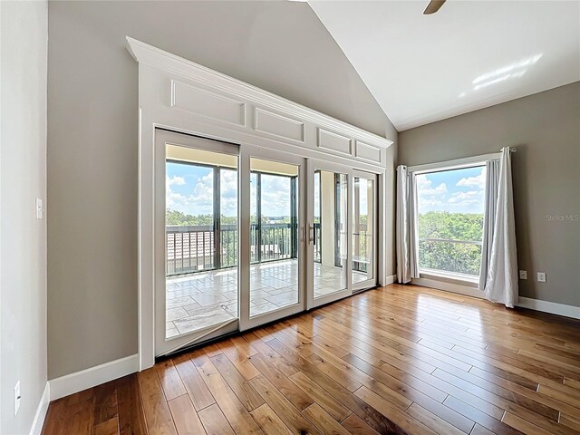 204 Quayside Cir Unit 601, Maitland, FL 32751 - unfurnished room with lofted ceiling and wood finished floors