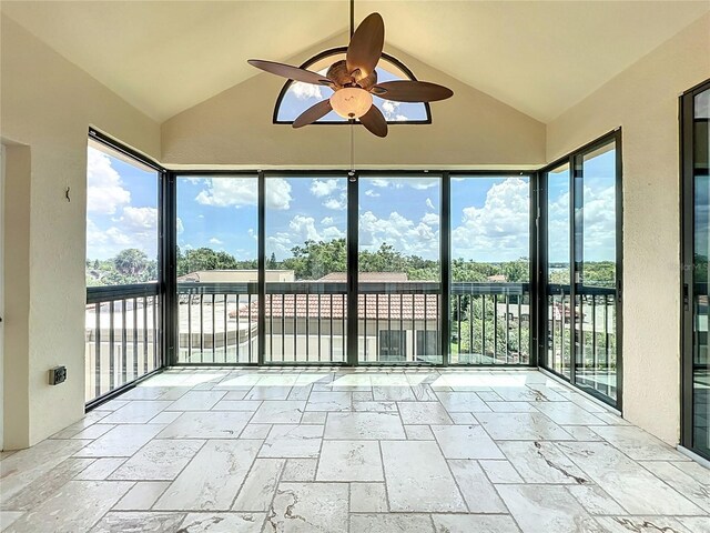 204 Quayside Cir Unit 601, Maitland, FL 32751 - unfurnished sunroom featuring lofted ceiling, stone tile flooring, and healthy amount of natural light