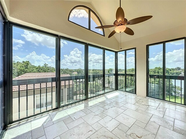 204 Quayside Cir Unit 601, Maitland, FL 32751 - unfurnished sunroom featuring stone tile flooring, healthy amount of natural light, vaulted ceiling, and a textured wall