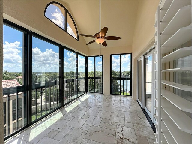 204 Quayside Cir Unit 601, Maitland, FL 32751 - unfurnished sunroom with stone tile flooring and high vaulted ceiling
