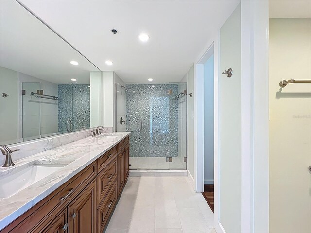 204 Quayside Cir Unit 601, Maitland, FL 32751 - bathroom with a shower stall, double vanity, tile patterned floors, and recessed lighting
