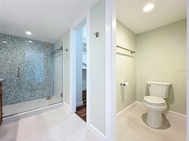 204 Quayside Cir Unit 601, Maitland, FL 32751 - bathroom with tile patterned flooring, a stall shower, recessed lighting, a walk in closet, and vanity