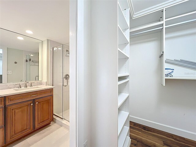 204 Quayside Cir Unit 601, Maitland, FL 32751 - full bathroom with vanity, a stall shower, and wood finished floors