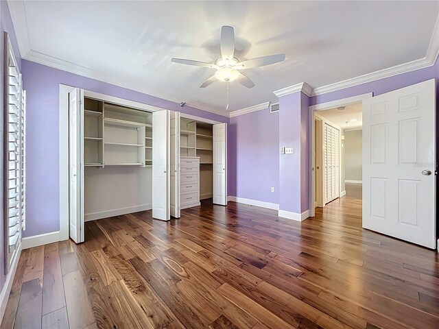 204 Quayside Cir Unit 601, Maitland, FL 32751 - unfurnished bedroom with two closets, dark wood-style floors, crown molding, and a ceiling fan