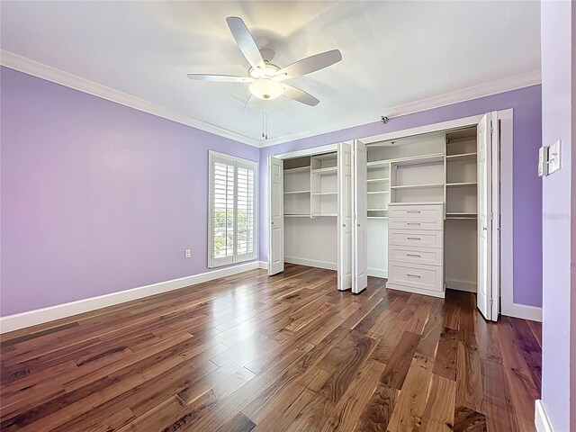 204 Quayside Cir Unit 601, Maitland, FL 32751 - unfurnished bedroom featuring multiple closets, ornamental molding, dark wood-type flooring, and a ceiling fan