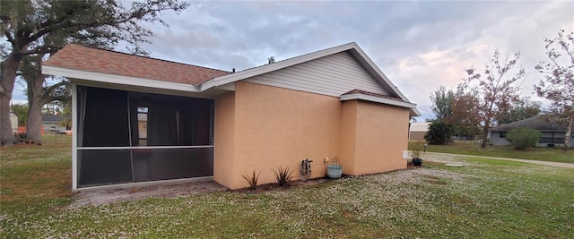 1835 Rival Ter, North Port, FL 34286 - view of property exterior with a sunroom, stucco siding, and a yard