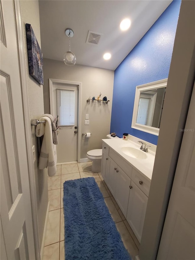 1835 Rival Ter, North Port, FL 34286 - bathroom with toilet, vanity, and tile patterned flooring