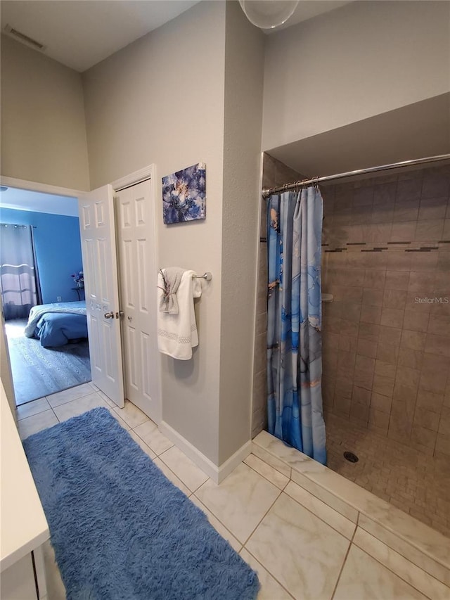 1835 Rival Ter, North Port, FL 34286 - bathroom featuring ensuite bath, tiled shower, tile patterned flooring, and baseboards