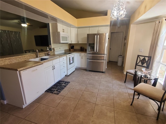 1835 Rival Ter, North Port, FL 34286 - kitchen featuring white appliances, a sink, light tile patterned flooring, white cabinetry, and a peninsula