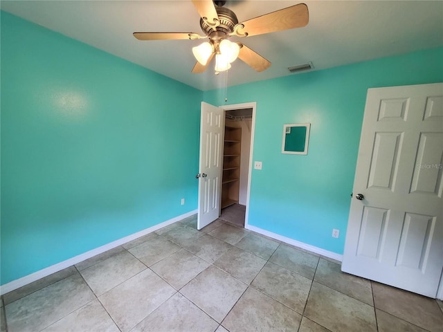 1835 Rival Ter, North Port, FL 34286 - unfurnished bedroom featuring baseboards, light tile patterned flooring, ceiling fan, and a closet