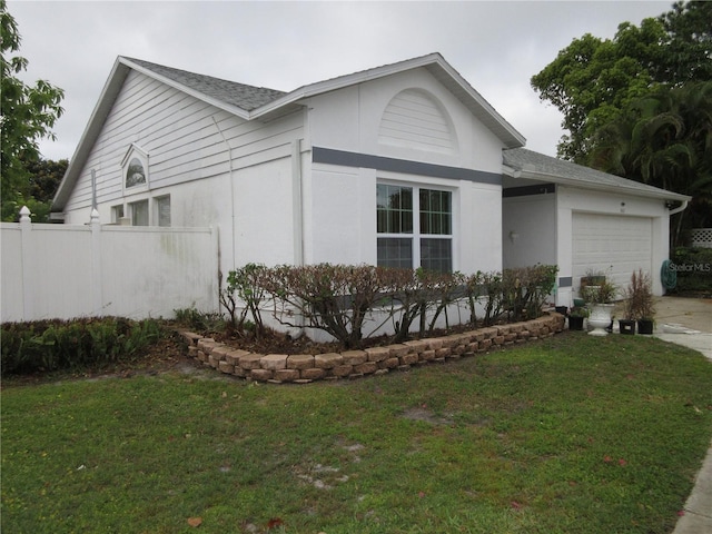 362 White Marsh Cir, Orlando, FL 32824 - view of front of house featuring an attached garage, driveway, a shingled roof, and stucco siding