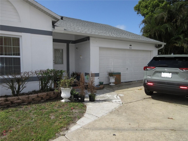 362 White Marsh Cir, Orlando, FL 32824 - view of front facade featuring a shingled roof, stucco siding, concrete driveway, and a garage