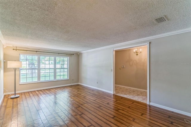 403 Broadview Ave, Altamonte Springs, FL 32701 - empty room featuring ornamental molding, a textured ceiling, wood-type flooring, and a chandelier