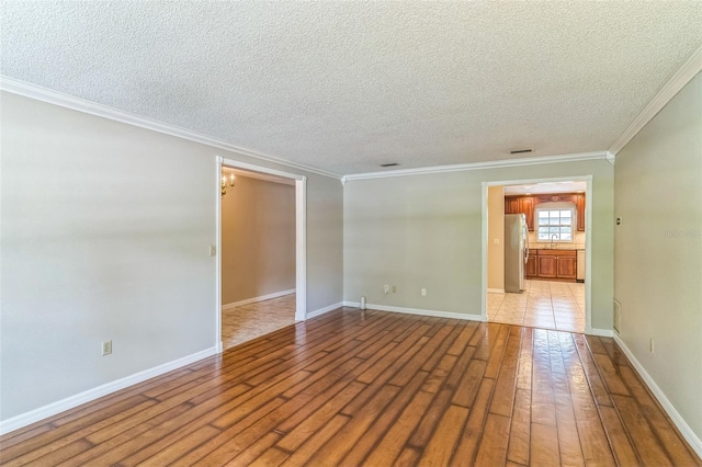 403 Broadview Ave, Altamonte Springs, FL 32701 - empty room featuring hardwood / wood-style flooring, a textured ceiling, and crown molding