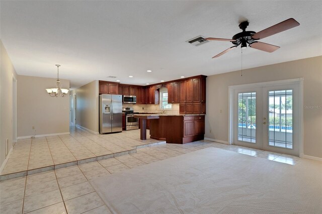 403 Broadview Ave, Altamonte Springs, FL 32701 - kitchen with stainless steel appliances, a chandelier, light tile patterned flooring, light countertops, and french doors