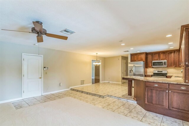 403 Broadview Ave, Altamonte Springs, FL 32701 - kitchen featuring stainless steel appliances, light tile patterned floors, recessed lighting, ceiling fan, and light stone counters