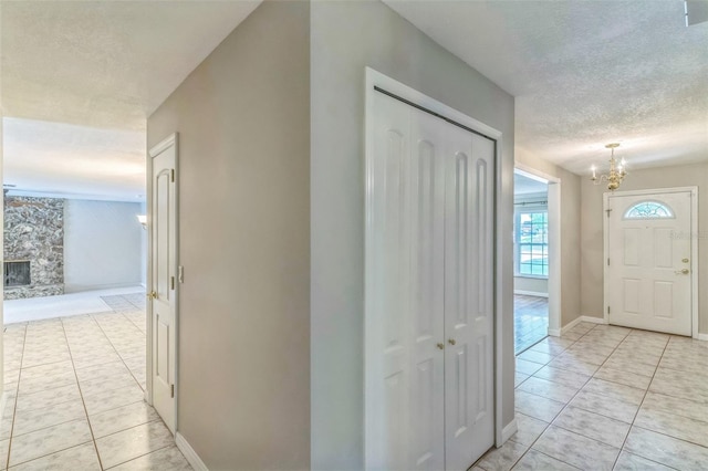 403 Broadview Ave, Altamonte Springs, FL 32701 - hallway with light tile patterned floors, a chandelier, and a textured ceiling