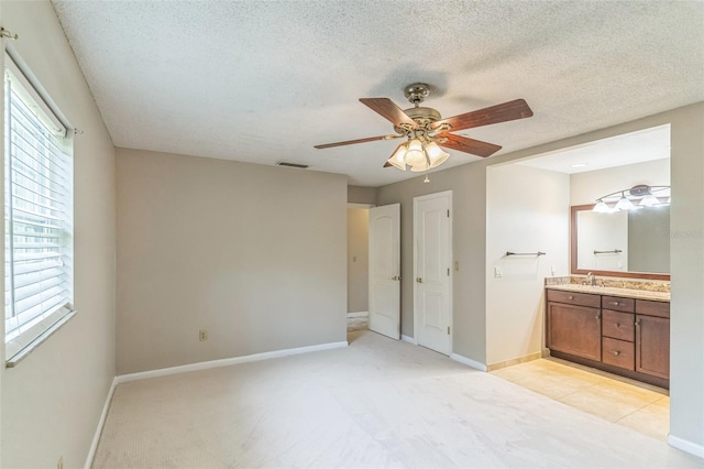 403 Broadview Ave, Altamonte Springs, FL 32701 - unfurnished bedroom featuring ensuite bathroom, light carpet, a textured ceiling, and ceiling fan