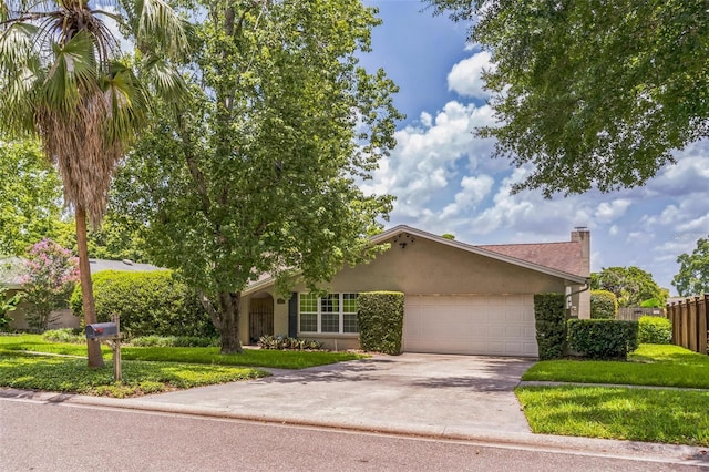 403 Broadview Ave, Altamonte Springs, FL 32701 - view of front of property with a garage, driveway, stucco siding, and a chimney