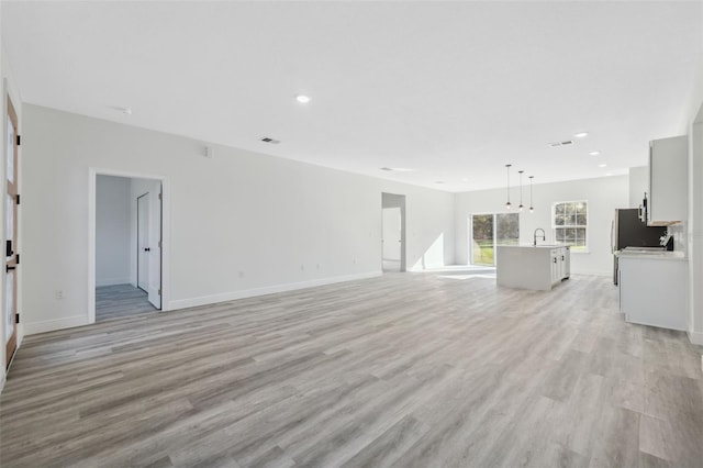 3159 SW 127th Lane Rd, Ocala, FL 34473 - unfurnished living room featuring light wood-type flooring and recessed lighting