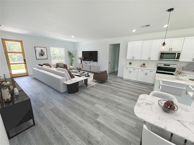 3159 SW 127th Lane Rd, Ocala, FL 34473 - living area featuring light wood finished floors and recessed lighting