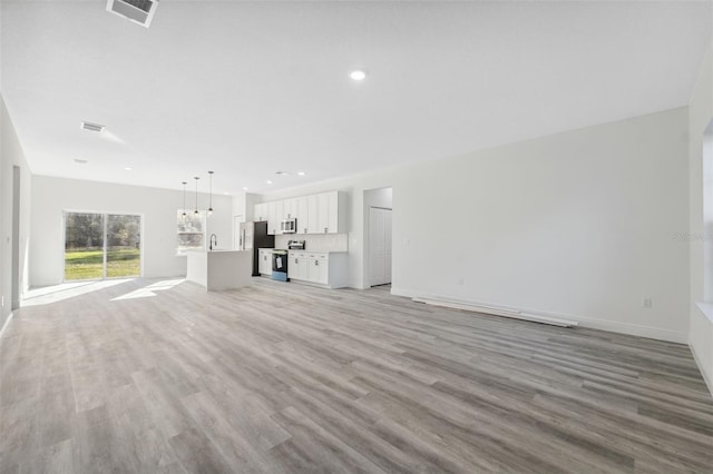 3159 SW 127th Lane Rd, Ocala, FL 34473 - unfurnished living room featuring light wood-type flooring and recessed lighting