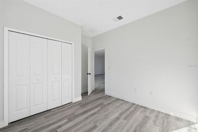 3159 SW 127th Lane Rd, Ocala, FL 34473 - unfurnished bedroom with wood finished floors and a closet