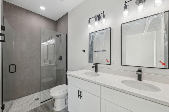 3159 SW 127th Lane Rd, Ocala, FL 34473 - bathroom with a stall shower, double vanity, and wood finished floors