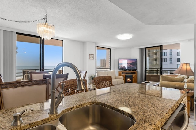 3023 S Atlantic Ave Unit 2050, Daytona Beach, FL 32118 - kitchen featuring stone countertops, plenty of natural light, open floor plan, and a textured ceiling