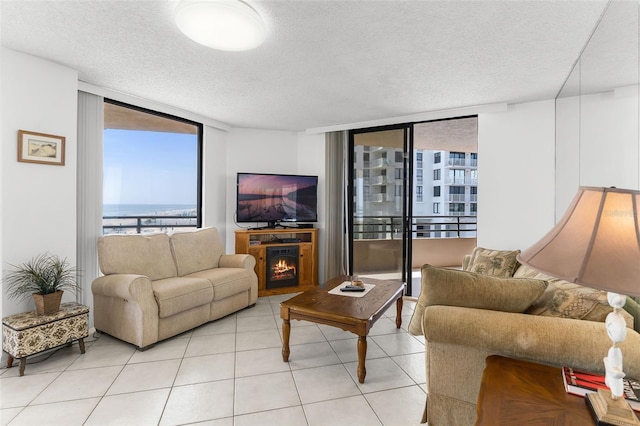 3023 S Atlantic Ave Unit 2050, Daytona Beach, FL 32118 - living room with expansive windows, a textured ceiling, and light tile patterned flooring