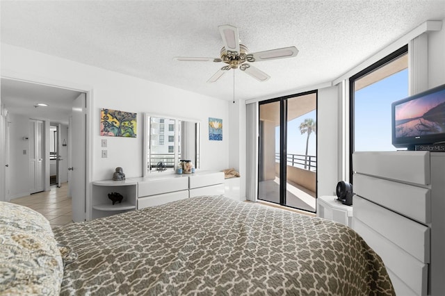 3023 S Atlantic Ave Unit 2050, Daytona Beach, FL 32118 - bedroom featuring access to outside, multiple windows, a textured ceiling, light tile patterned floors, and ceiling fan