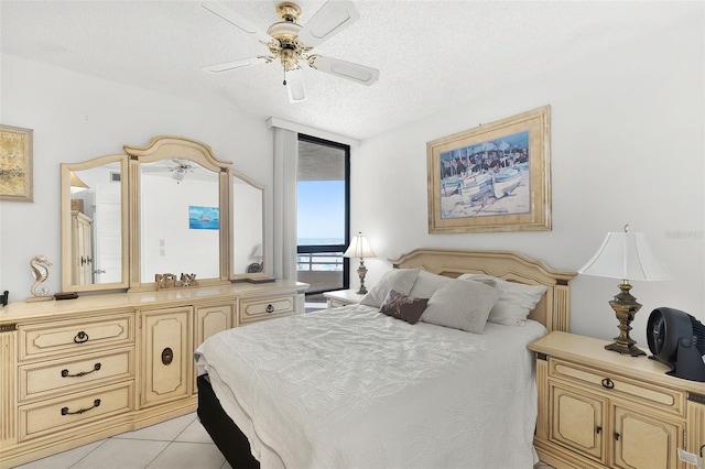 3023 S Atlantic Ave Unit 2050, Daytona Beach, FL 32118 - bedroom with light tile patterned floors, a textured ceiling, and ceiling fan