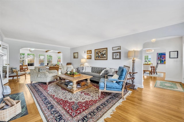 624 Richmond St, Orlando, FL 32806 - living area with arched walkways, healthy amount of natural light, crown molding, and light wood-style floors