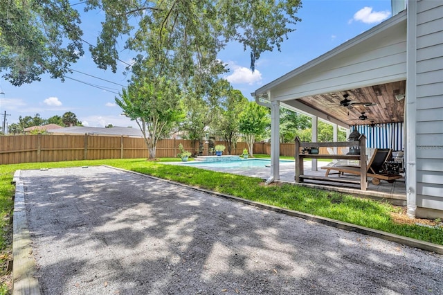624 Richmond St, Orlando, FL 32806 - fenced backyard with a ceiling fan and a patio