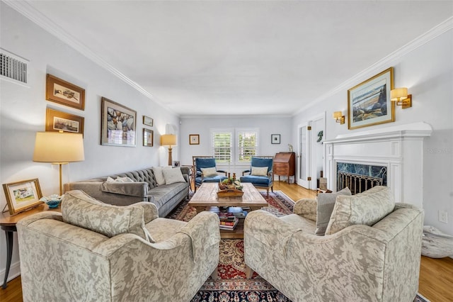 624 Richmond St, Orlando, FL 32806 - living room with crown molding, wood finished floors, and a premium fireplace