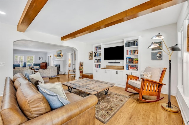 624 Richmond St, Orlando, FL 32806 - living area with arched walkways, beamed ceiling, light wood-type flooring, and a fireplace