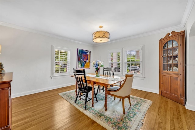 624 Richmond St, Orlando, FL 32806 - dining area with plenty of natural light, light wood-style flooring, and ornamental molding