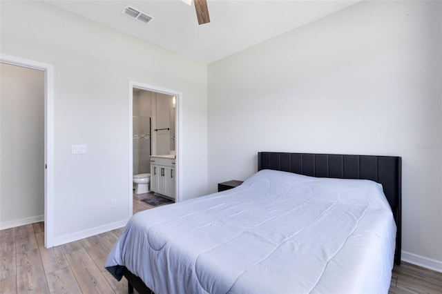 5677 Cedar Chase Dr, Saint Cloud, FL 34771 - bedroom with light wood-style flooring, connected bathroom, and a ceiling fan