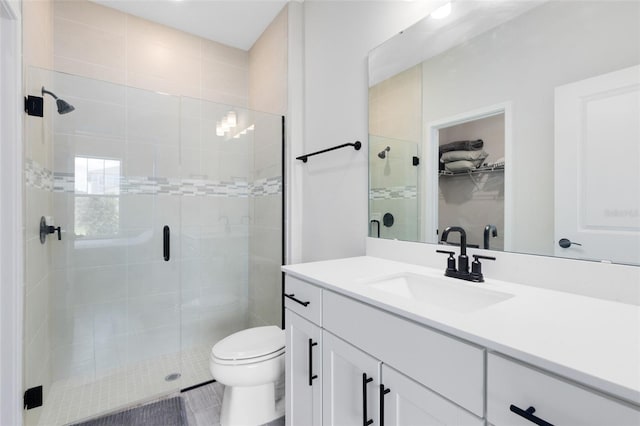5677 Cedar Chase Dr, Saint Cloud, FL 34771 - bathroom featuring vanity, a stall shower, and a walk in closet