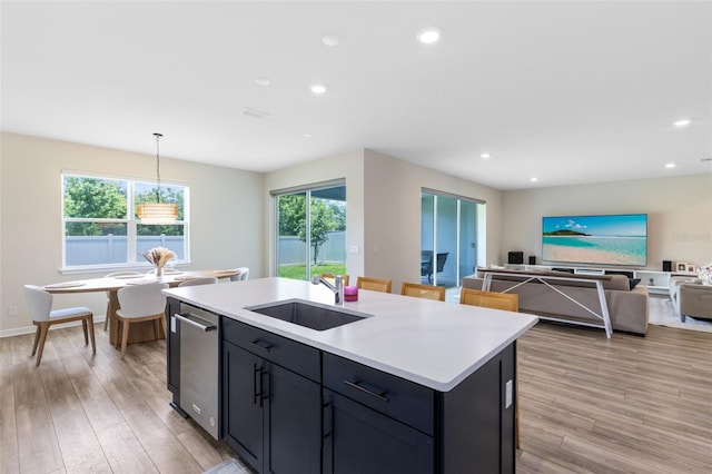 5677 Cedar Chase Dr, Saint Cloud, FL 34771 - kitchen with light wood-style flooring, light countertops, an island with sink, recessed lighting, and open floor plan