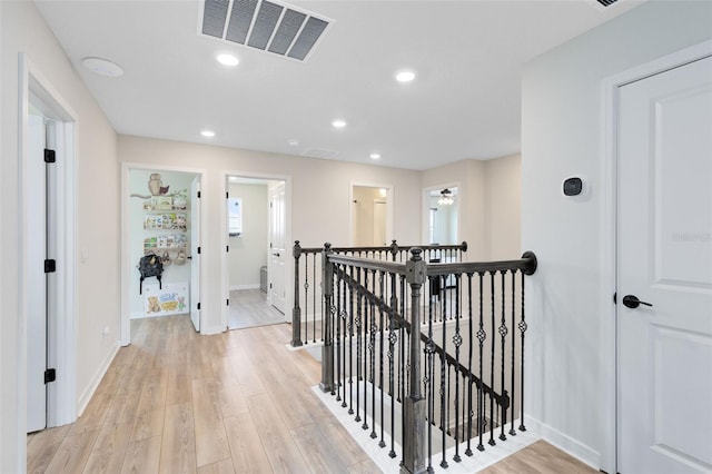 5677 Cedar Chase Dr, Saint Cloud, FL 34771 - hallway with an upstairs landing, light wood finished floors, and recessed lighting