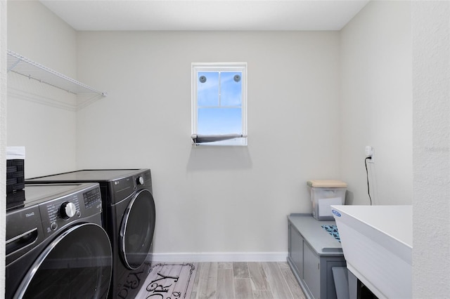 5677 Cedar Chase Dr, Saint Cloud, FL 34771 - laundry area featuring separate washer and dryer and light wood-type flooring